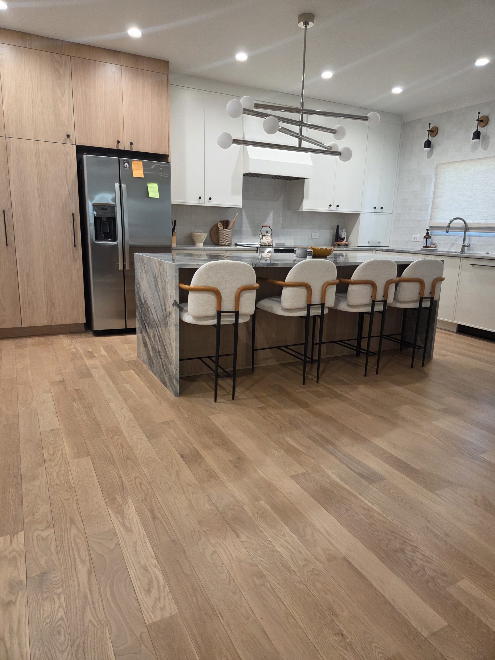 Hardwood flooring in a modern kitchen and dining area