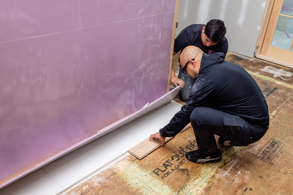 Flooring technician installing subfloor underlayment, Raleigh NC