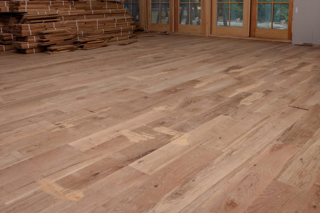 Stacked hardwood flooring planks ready for installation in Raleigh NC home